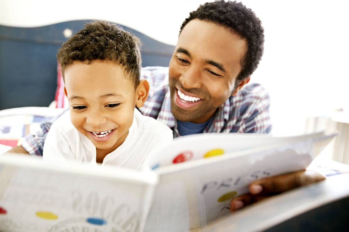 father and son reading book