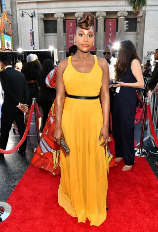2019: Issa Rae styled in a yellow Grecian dress by Oscar de la Renta. - (Photo by Paras Griffin/Getty Images for NAACP)