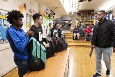 Students open their backpacks for a random search. - (Photo: Lara Solanki/BET)