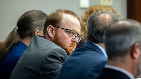 Travis McMichael sits with his attorneys before the start of closing arguments to the jury during the trial of Ahmaud Arbery's alleged killers at Glynn County Superior Court on November 22, 2021 in Brunswick, Georgia.  