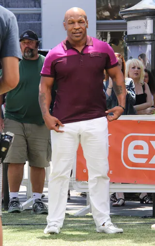 The Champ Is Here - Mike Tyson is all smiles and muscles at L.A.'s the Grove during his televised interview with Extra's Mario Lopez.(Photo: Parisa/Splash News)