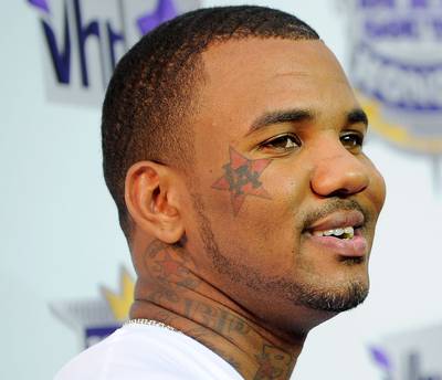 Chuck Taylor - Paying homage to his rap alias, Chuck Taylor, Game (born Jayceon Terrell Taylor) has the logo for Converse All-Stars sneakers drawn on his neck.  (Photo: Jemal Countess/Getty Images)