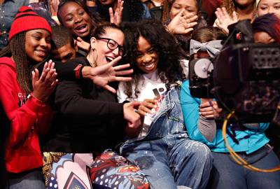 In the Midst of It All - Recording artist SZA (C) poses with audience members. (Photo: Cindy Ord/BET/Getty Images for BET)