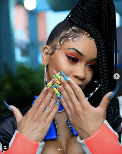 Saweetie&nbsp; - Saweetie&nbsp;wants you to “Tap In” this summer! Dropping her new single just in time for the heatwave, the rapper left us speechless when she gave us an up-close of her colorful graffiti nails worn for the music video.&nbsp;Did we mention the nails glow in the dark? Celebrity nail artist,&nbsp;CustomTnails&nbsp;is definitely a game-changer!&nbsp; (Photo:&nbsp;Saweetie/ Instagram) Saweetie/ Instagram