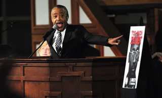 Supporting Troy Davis - Rev. Al Sharpton speaks to a standing-room only crowd during a prayer service at Ebenezer Baptist Church in support of death row inmate Troy Davis, shown in the poster next to Sharpton, after a march from downtown Atlanta to the church on Friday, Sept. 16, 2011. (Photo:&nbsp; AP Photo/David Tulis)