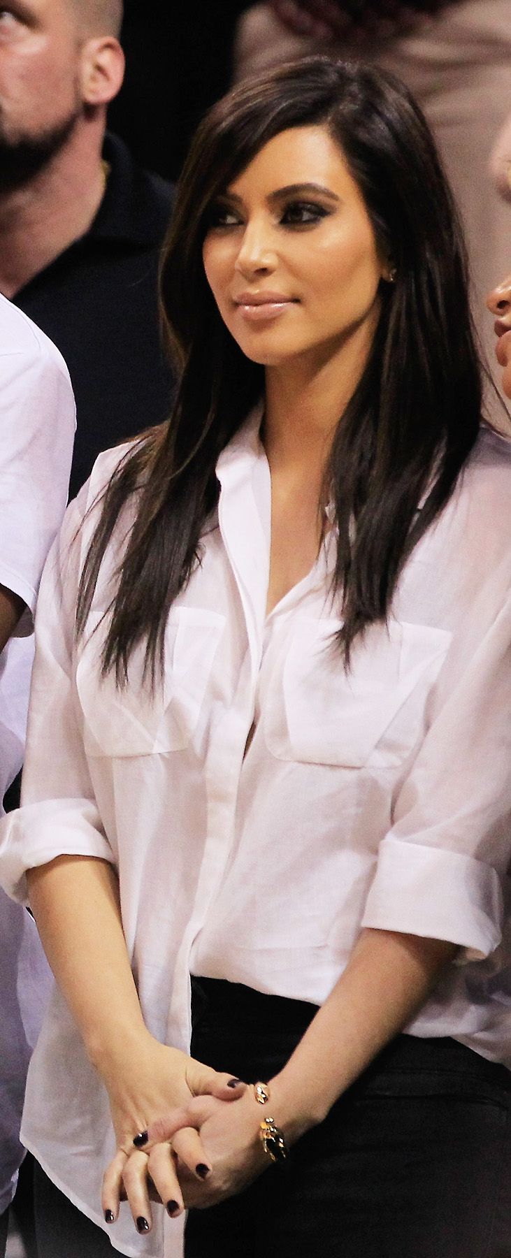 Keeping Comfortable - Looking comfy (as far as Kardashian Klothes go) in a blouse-y button-down top and black pants, Kim caught a New York Knicks game court-side with Kanye West on December 6.  (Photo: Christopher Trotman/Getty Images)