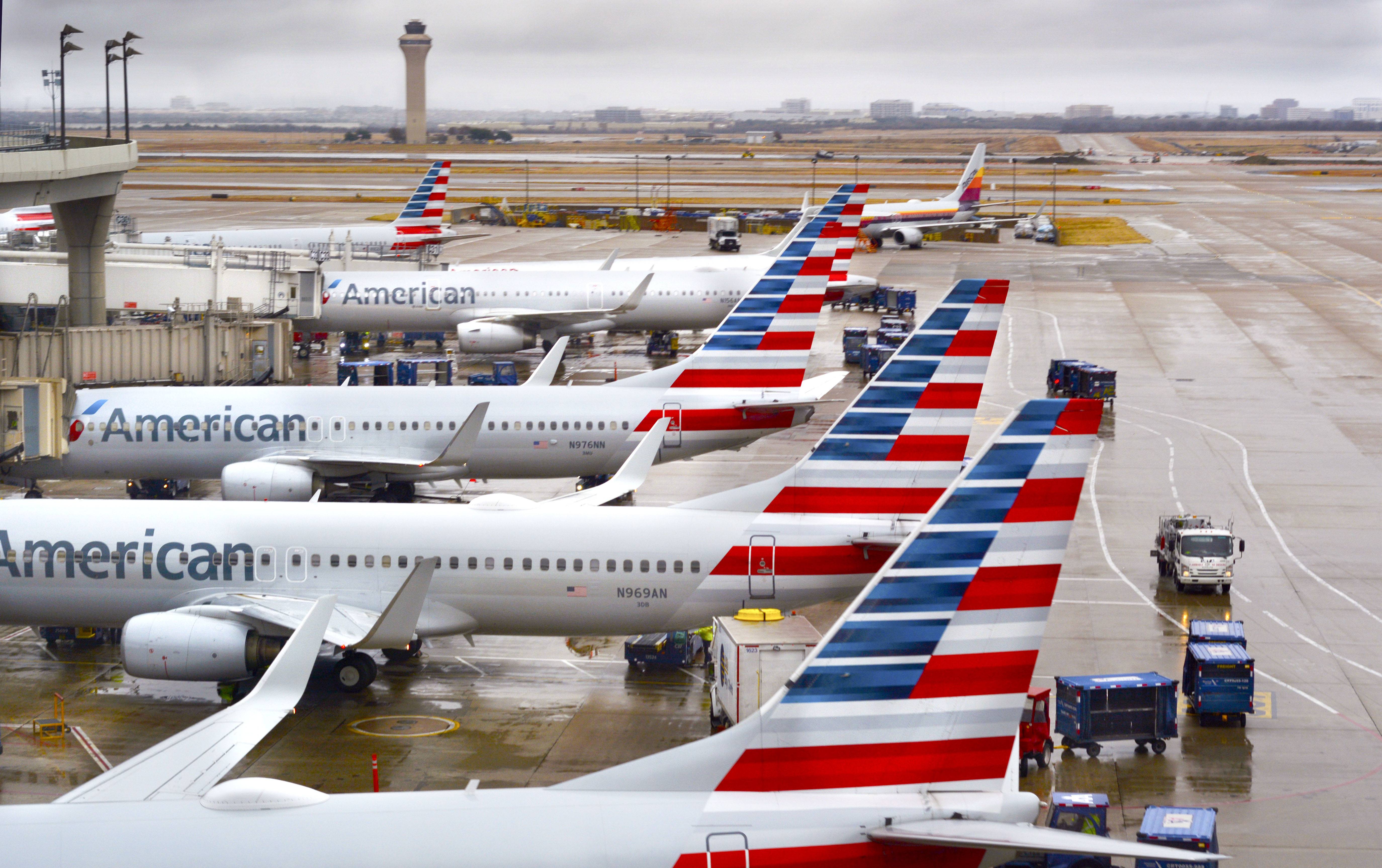 DALLAS, TEXAS - DECEMBER 8, 2018: American Airlines passenger jets parked at their gates on a rainy morning at Dallas/Fort Worth International Airport which serves the Dallas/Fort Worth, Texas, metroplex area in Texas. (Photo by Robert Alexander/Getty Images)