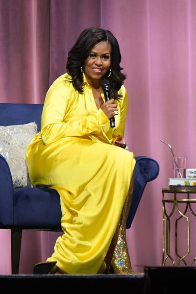The Golden First Lady - This former first lady literally lights up a room! Michelle Obama sat down with Sarah Jessica Parker at Barclay's Center in Brooklyn, New York to discuss her hit memoir, &quot;Becoming.&quot; For the last stop of the first leg of her book tour, Mrs. Obama slayed in a full Balenciaga look fresh off the runway, including&nbsp;$3,351.05 golden, holographic thigh high boots that she perfectly paired with a metallic, saffron dress from Balenciaga's Spring 2019 collection. (Photo: Dia Dipasupil/Getty Images)&nbsp;