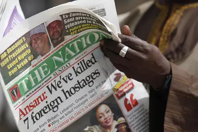 Nigerian Islamist Group Kills Hostages - The Nigerian Islamist group Ansaru killed seven hostages and posted a video of the bodies on the Internet. On the video, a gunman stands next to a pile of dead bodies. The seven hostages were construction workers from Britain, Italy, Greece and Lebanon and had been held since February in northern Nigeria’s Bauchi state.&nbsp;(Photo: AP Photo/Sunday Alamba)