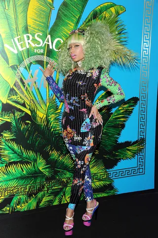 Nicki Minaj - Nicki holds tight to her colorful fashions in a floral Versace for H&amp;M mini-and-hot-pants ensemble and curly green wig.(Photo: Jamie McCarthy/Getty Images for Versace for H&amp;M)