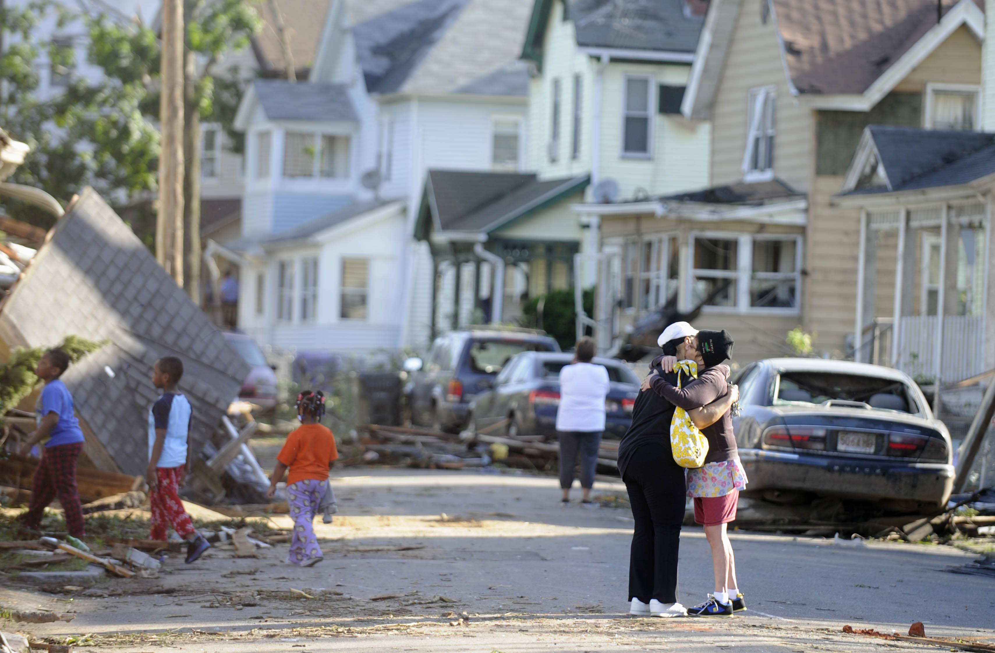 Providing Succor - The morning after the tornado residents comfort each other in Springfield.(Photo: AP Photo/Jessica Hill)