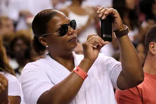Courtside Queen\r - Queen Latifah documents the action at game one of the 2011 NBA finals. (Photo by Mike Ehrmann/Getty Images)