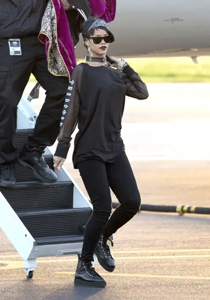 Goth girl wearing steam punk glasses and dark hoodie is looking