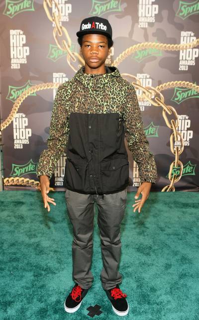 Astro&nbsp; - Astro keeps it cool in a Grade A Tribe fitted, green cheetah print jacket, slacks and vintage sneakers accented with red shoe laces.(Photo: Bennett Raglin/BET/Getty Images for BET)