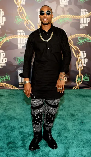 B.o.B - "We In This" MC B.o.B couples a black-and-white 'fit with black combat boots and opts for gold accessories, proving gold is officially back on trend.(Photo: Bennett Raglin/BET/Getty Images for BET)
