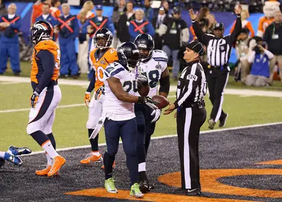 &quot;About That Action Boss&quot; - Camera-shy running back Marshawn Lynch scored the first touchdown, a 1-yard plunge in the second quarter, to give the Seahawks a 15-0 lead. The TD came after Kam Chancellor intercepted Peyton Manning's pass in Denver territory. (Photo: Christian Petersen/Getty Images)