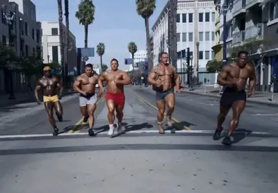Go Daddy&nbsp; - Often criticized for sexist commericals in the past, Go Daddy is instead using humor to drive their next ad. In a teaser, NASCAR driver Danicka Patrick is in a body suit that makes her appear to have the muscles of a body builder and runs with with a pack of men with big muscles too.&nbsp;(Photo: GoDaddy)