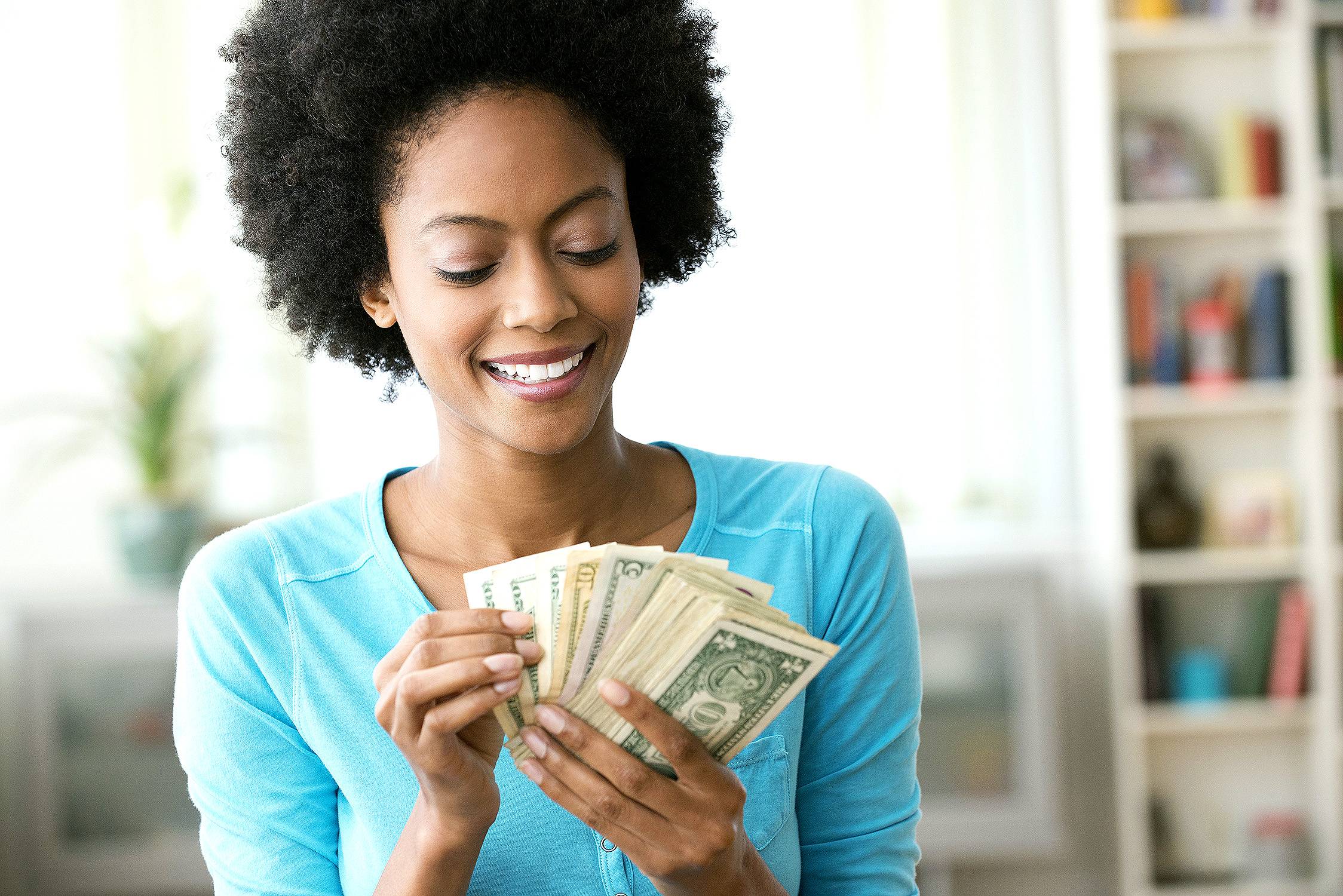 woman holding a wad of money