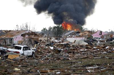 On Fire - The tornado's path was 17 miles long and 1.3 miles wide, and had winds up to 200 mph. It flattened entire neighborhoods, set buildings on fire and landed a direct blow on an elementary school.&nbsp; (Photo: AP Photo Sue Ogrocki)