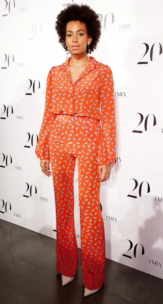 Fashion Star - Solange loves a bold print and she's wearing the hell out of this matching orange and silver leaf printed blouse and high-waisted trouser at the Intermix 20th Anniversary Celebration at the New Museum in New York City. (Photo: Concordia/Getty Images)