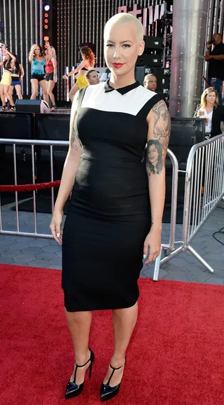 Amber Demure - Model Amber Rose, known for her super sexy and at times outrageous get-ups, arrives at the premiere of Universal Pictures' Fast &amp; Furious 6 in a modest tuxedo-inspired sheath dress. (Photo: Frazer Harrison/Getty Images)
