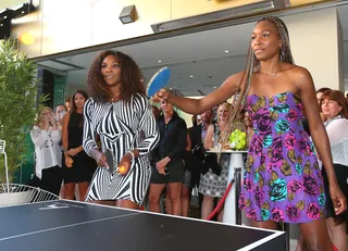 All Fun and Games - Sibling tennis champions Venus and Serena Williams play table tennis against an unseen opponent while Olsen Hotel guests look on at a Welcome to Melbourne event in Australia.&nbsp; (Photo: Scott Barbour/Getty Images)