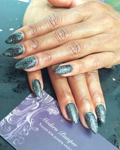 Ariane Andrew - This WWE Diva is more than tough enough. Just peep her fierce emerald green polish with silver micro glitter, and tell us she’s not winning.(Photo: Modern Pamper Salon via Instagram)
