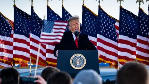President Donald Trump speaks to supporters at Joint Base Andrews before boarding Air Force One for his last time as President on January 20, 2021. Trump is traveling to his Mar-a-Lago Club in Palm Beach, Fla. (photo by Pete Marovich for The New York Times)

NYTINAUG