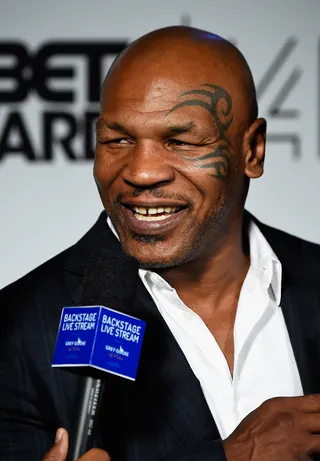 Trademark Smile - Mike Tyson shoots a grin while being interviewed. Of course, it's another classic shot of his face tattoo.(Photo: Frazer Harrison/BET/Getty Images for BET)