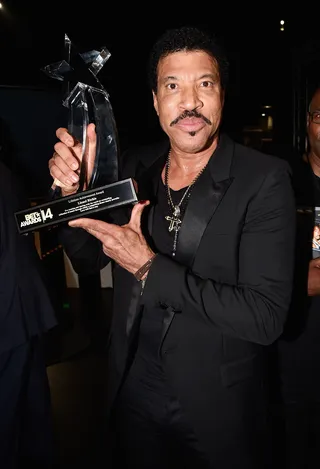 Trophies! - Lionel Richie holds up his Lifetime Achievement Award. It was a glorious moment and the singer spoke highly of the Commodores and Berry Gordy. (Photo: Frazer Harrison/BET/Getty Images for BET)