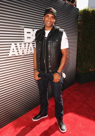 Boris Kodjoe - The&nbsp;Real Husbands of Hollywood&nbsp;star flashes his trademark grin in a cool mix of street wear, comprised of a pebbled leather vest layered over a graphic tee, slim denim and leather high-tops. Nice.  (Photo: Kevin Mazur/BET/Getty Images for BET)