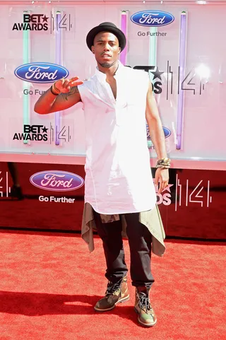 B.o.B - The Atlanta-reared rapper keeps cool in a breezy white tunic teamed with slim denim, camo-print boots and a black fedora.  (Photo: Earl Gibson III/Getty Images for BET)