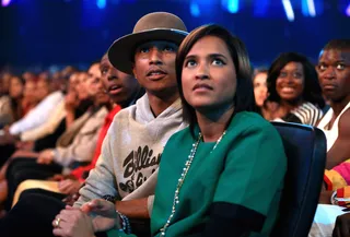 Look, Up in the Sky? - Pharrell Williams and his wife, Helen Lasichanh, marveled at the screens. We can only guess what they were looking at, but it had their eyes blingin' like the Neptunes' sound (peeew peeww). (Photo: Christopher Polk/BET/Getty Images for BET)