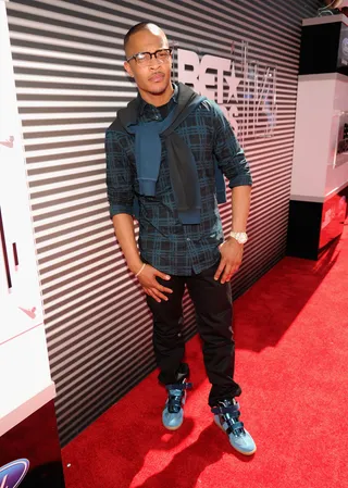 T.I. - The “No Mediocre” rapper brings out his softer side, hitting the red carpet in a subdued button-down, adding a two-tone sweater draped around his neck and fresh baby blue and navy high tops.(Photo: Kevin Mazur/BET/Getty Images for BET)