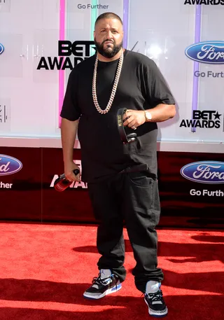 DJ Khaled - Who said they don’t love him no more? The hip hop heavyweight maintains his boss status in a classic black tee, dark denim and enough gold and ice to cool L.A.’s current heatwave.  (Photo: Earl Gibson III/Getty Images for BET)