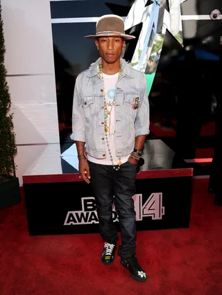 Pharrell - Let’s take a moment to mourn the loss of the “Happy” singer’s Mountie hat. Ok, now let’s take another to admire his artsy ensemble, consisting of a light wash Levi’s jacket adorned with custom buttons, several jade and gold Chanel necklaces, slim denim and custom Adidas kicks.  (Photo: Kevin Mazur/BET/Getty Images for BET)