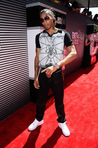 Snootie Wild  - It’s all black and white for the Memphis-reared MC, who steps out in an all-over graphic T-shirt, slim black denim and crisp white kicks for contrast. (Photo: Frazer Harrison/BET/Getty Images for BET)