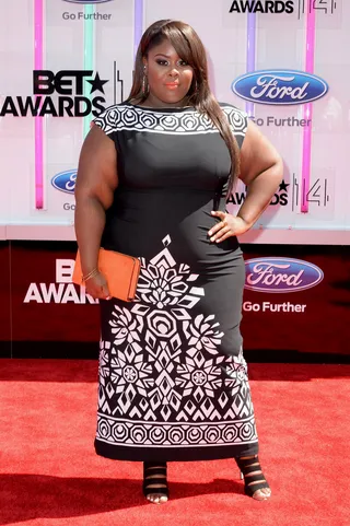 Raven Goodwin - The actress goes bold in a chic printed sheath by Melissa Masse, and we’re obsessed with her tangerine lips and matching clutch.  (Photo: Earl Gibson III/Getty Images for BET)