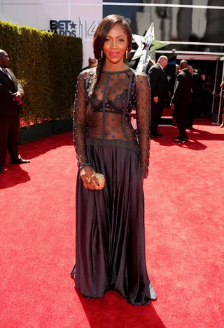 Tiwa Savage - The “Wanted” songstress certainly grabs our attention in her gutsy navy frock with sheer bodice. Finishing her look, she adds a perfect fishtail braid and bubblegum pink lips.  (Photo: Kevin Mazur/BET/Getty Images for BET)
