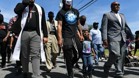 NORTH CAROLINA, USA - MAY 02: Reverend Greg Drumwright (R) leads a march as Khalil Ferebee (2nd L) the son of Andrew Brown, Jr. and daughter of Andrew Brown, Jr., Dranae Dunbar (2nd R), accompany him during a protest after the killing of Andrew Brown Jr. demanding the release of the body camera videos the day before the funeral in Elizabeth City, NC, United States on May 02, 2021. The march was led by Reverend Greg Drumwright joined by Reverend Barber and the family of Andrew Brown Jr. as the protesters were asking for justice after Pasquotank County Sheriff's deputies killed Mr. Brown on April 21. (Photo by Peter Zay/Anadolu Agency via Getty Images)