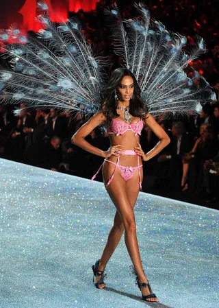 Joan Smalls - The supermodel leaves spectators in awe as she commands the runway in these wispy peacock feather wings styled with a garter belt and strategically placed bows.&nbsp;&nbsp;&nbsp;   (Photo: Bryan Bedder/Getty Images for Swarovski)
