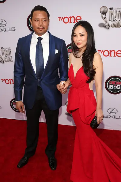 Terrence Howard - Marriage looks good on him. The Best Man Holiday star and his better half steal the spotlight in stylish looks — a midnight blue blazer and scarlet red gown.  (Photo: Jesse Grant/Getty Images for NAACP Image Awards)