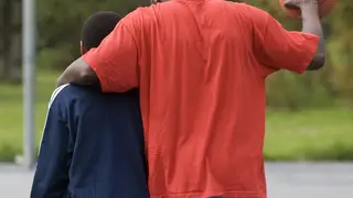 Father and son walking together at a park
