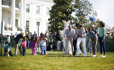 How They Roll - The president, first lady and daughters Malia and Sasha show visiting children how to do the Easter egg roll.&nbsp;(Photo: REUTERS/Jason Reed )