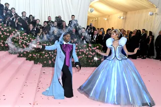 Princess Zendaya - Our girl Z has slowly become known to nail the MET Gala themes and the 2019 'Camp' theme was no different. Not only did she arrive in a custom Tommy Hilfiger gown looking like a brown Cinderella, with stylist Law Roach as her fairy god muva, Zendaya even left a glass slipper on the steps while carrying a custom&nbsp;Judith Leiber&nbsp;Swarovski crystal-embellished, Cinderella carriage clutch purse. We are here for the theatrics!&nbsp;(Photo: John Shearer/Getty Images for THR)
