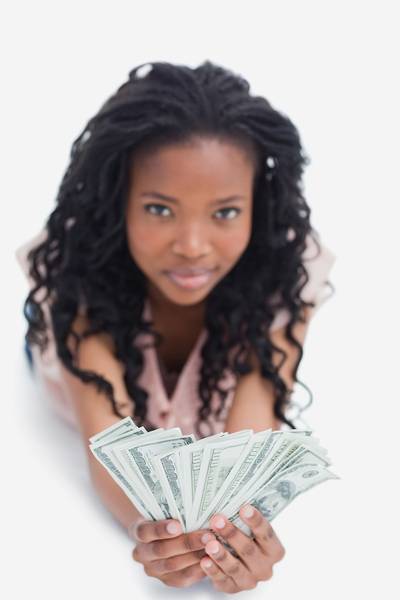 062014-b-real-investing-woman-holding-money-cash-savings-income.jpg