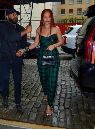 Fall Time RiRi - Fall in the summer but make it fashion! Rihanna battled the NYC heat and rain under her umbrella for her appearance on Late Night With Seth Meyer without breaking a sweat! She was spotted wearing a Fall 2019 OTW Dior, forest green, plaid, strapless jumpsuit while carrying her Azzedine Alaïa, miniature, leather&nbsp;tote&nbsp;in black&nbsp;crocodile. (Photo: Backgrid)