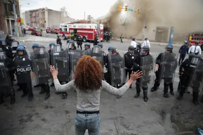 And it wasn't just a guy thing. - Just look at this woman facing down a line of police officers decked out in riot gear. What do you imagine she was thinking?(Photo: Chip Somodevilla/Getty Images)