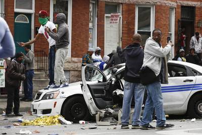 The looters did not care. - And to prove it, they damaged and stood atop a Baltimore Police car, almost daring law enforcement to do something. Their frustrations with the police, who have a notorious reputation for being abusive, was so high, the rioters decided to actually give the officers a real reason to come after them.(Photo: Drew Angerer/Getty Images)