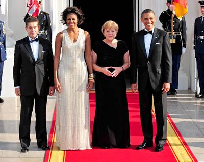 German State Dinner - Mrs. Obama shimmered on June 7, 2011, in an all-over embellished gown by Naeem Khan, who also designed the dress she wore at the Obama's state dinner for India's prime minister. The guests of honor on this night were German Chancellor Angela Merkel and her husband Joachim Sauer.&nbsp;(Photo: Kevin Dietsch/UPI/Landov)